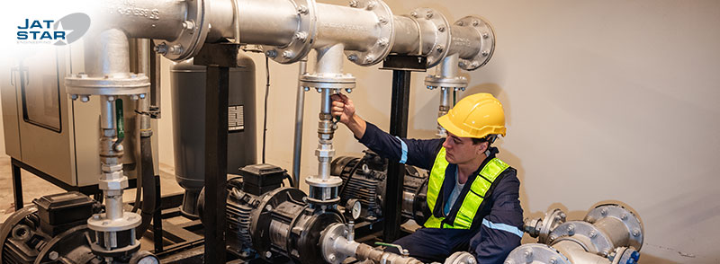 Engineers inspecting the inside plumbing and water valves of an industrial facility